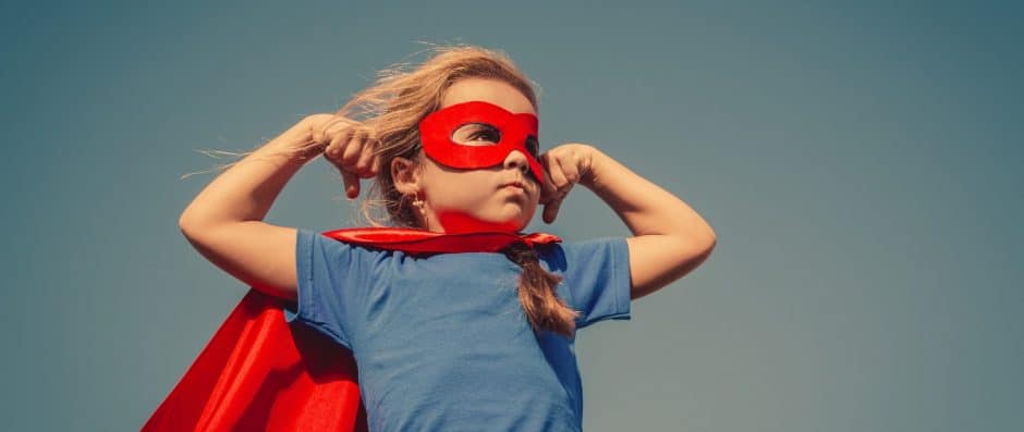 Little girl with superhero mask and cape